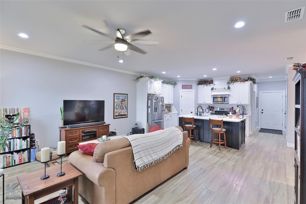 7329 Mountain View Road Abilene, TX 79602 - Photo 7 of 33 a living room with furniture and a flat screen tv