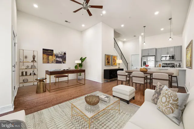 a living room with furniture and a wooden floor