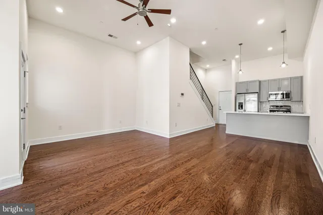 a view of a kitchen with a sink and wooden floor