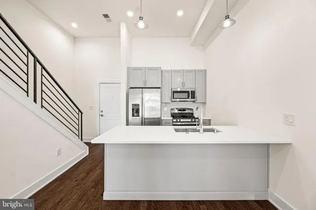 a large kitchen with stainless steel appliances