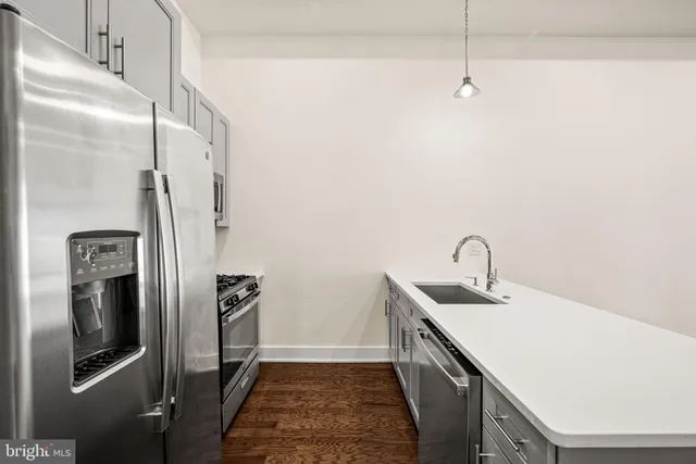a kitchen with stainless steel appliances a refrigerator sink and stove