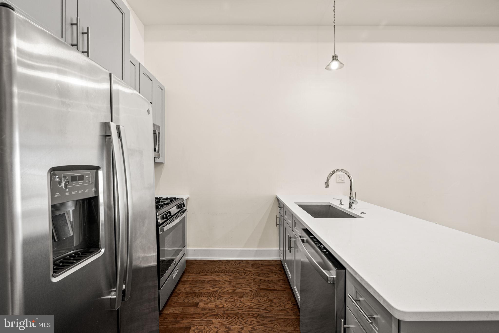 1115 North American Street, Unit D5 Philadelphia, PA 19123 - Photo 15 of 52 a kitchen with stainless steel appliances a refrigerator sink and stove