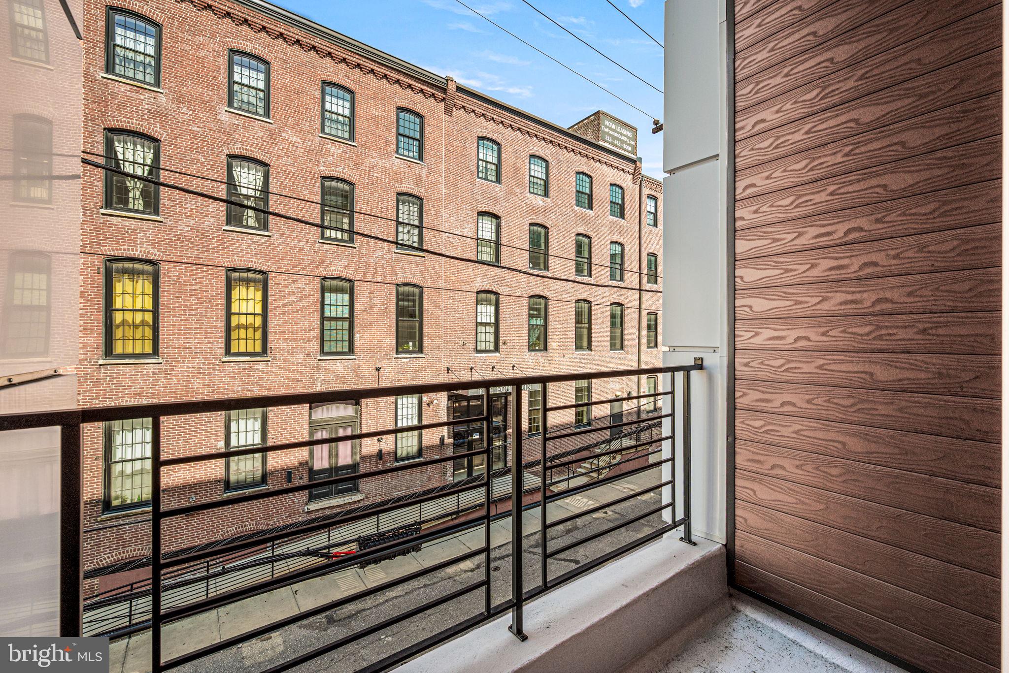 1115 North American Street, Unit D5 Philadelphia, PA 19123 - Photo 20 of 52 a view of a brick building next to a brick building