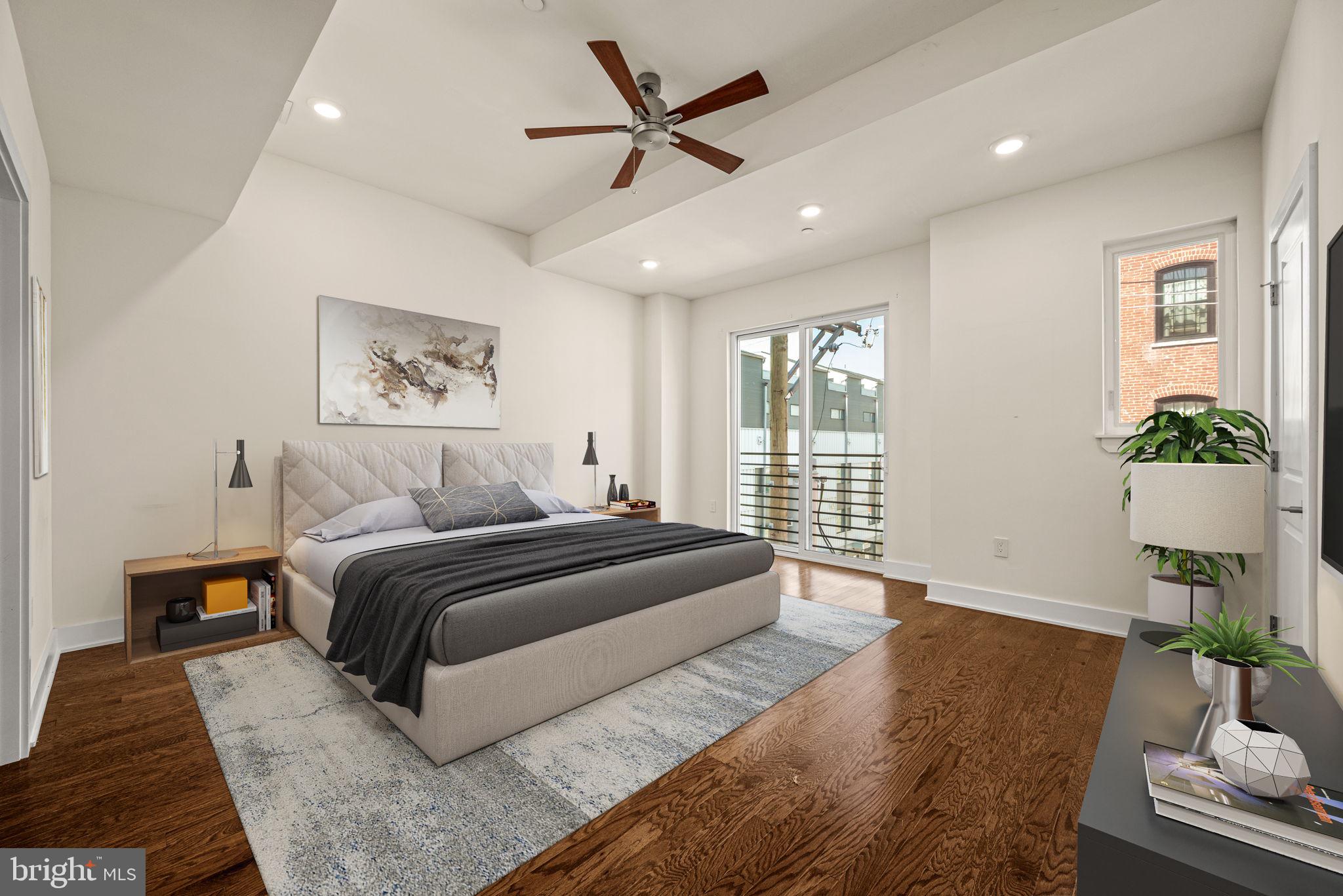 1115 North American Street, Unit D5 Philadelphia, PA 19123 - Photo 24 of 52 a spacious bedroom with a bed and wooden floor