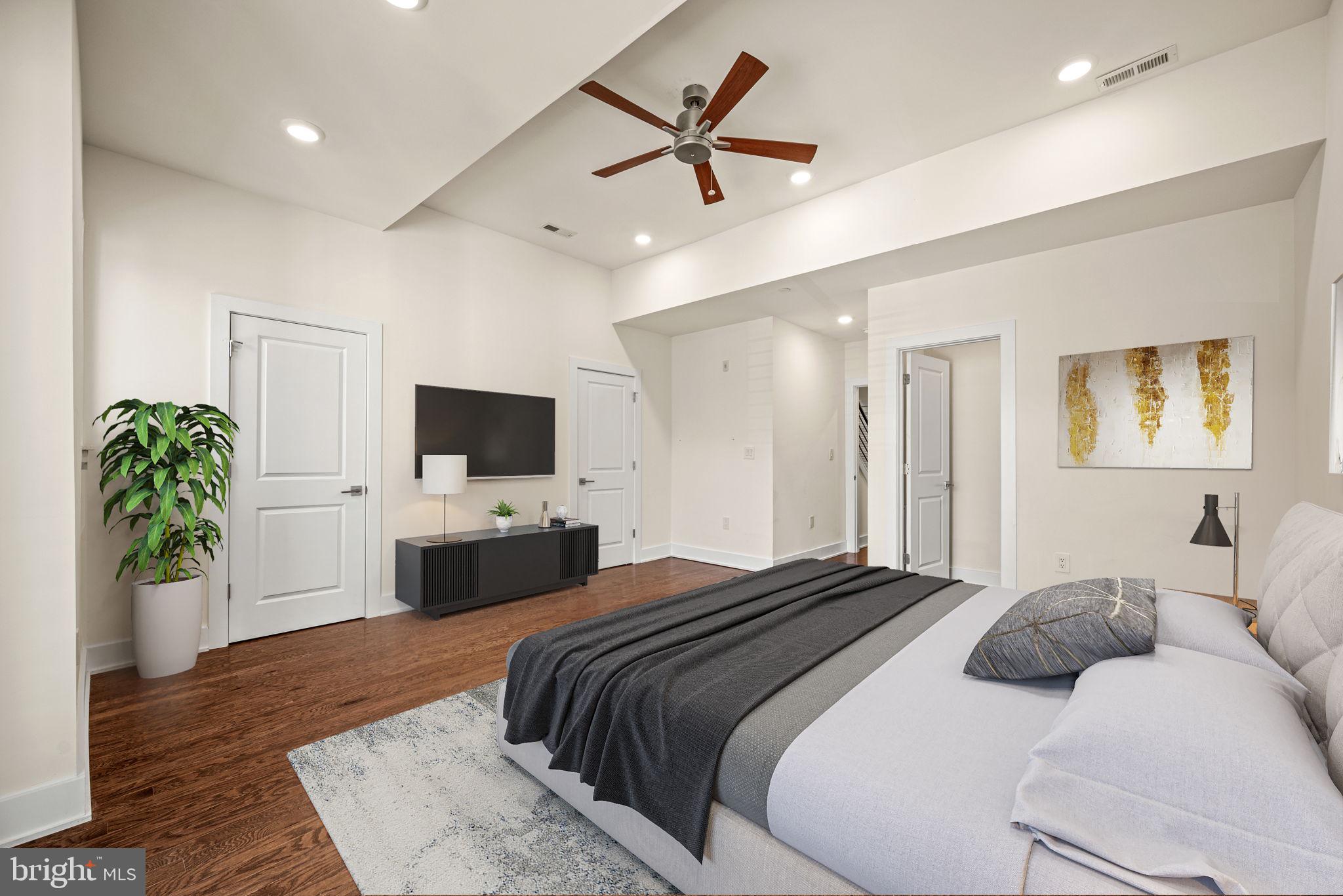 1115 North American Street, Unit D5 Philadelphia, PA 19123 - Photo 26 of 52 a bedroom with a bed and a flat screen tv