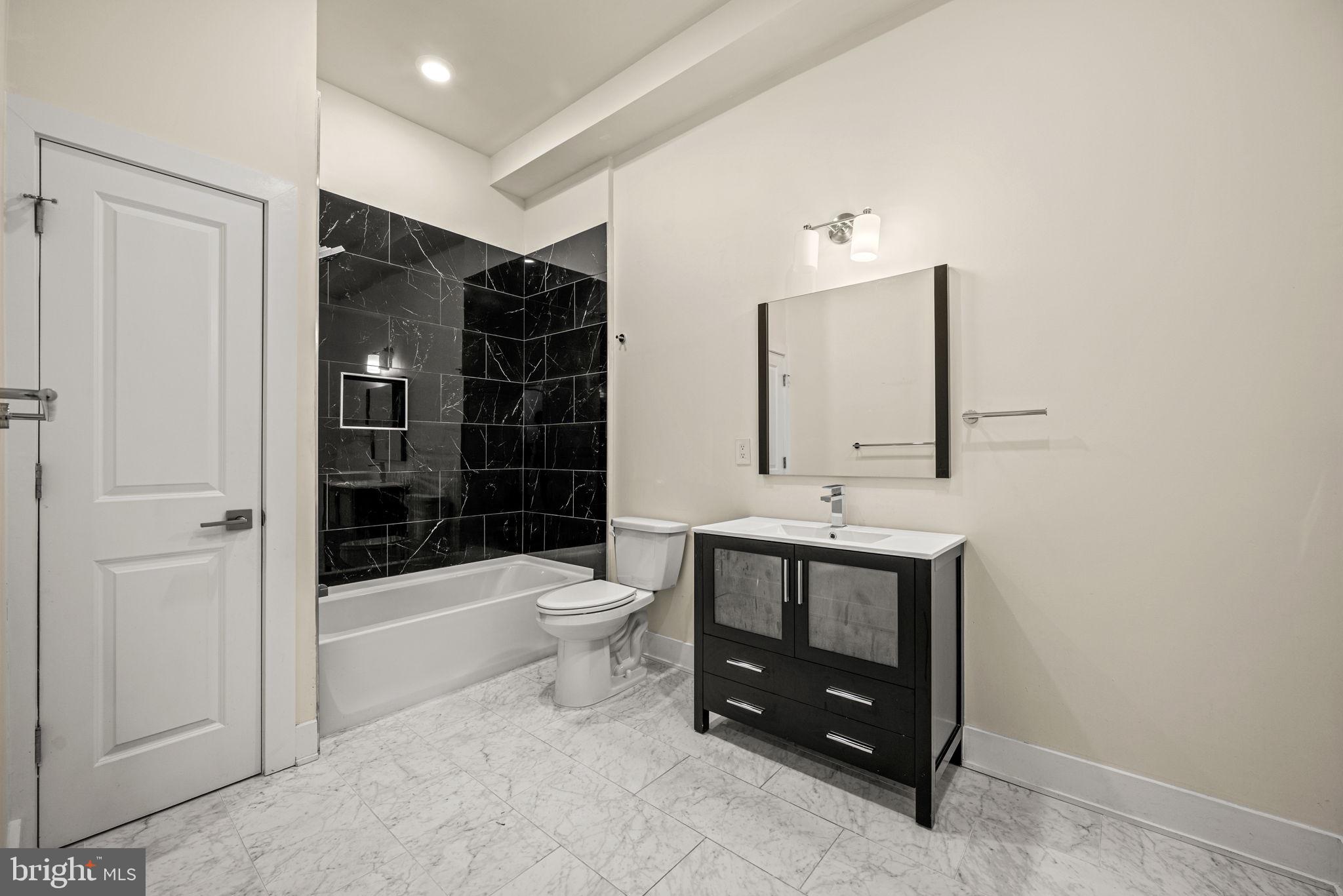 1115 North American Street, Unit D5 Philadelphia, PA 19123 - Photo 29 of 52 a bathroom with a sink toilet and shower