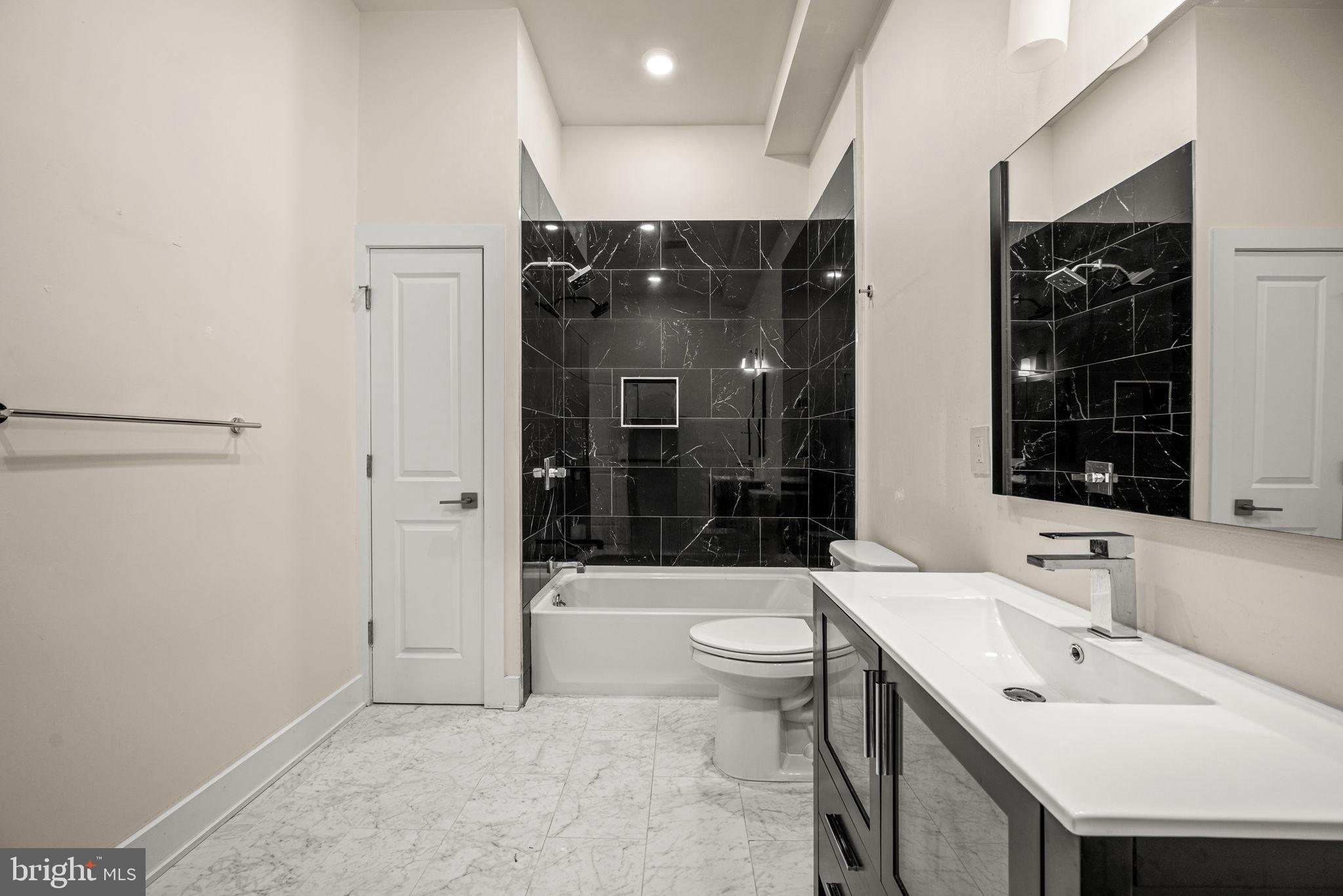 1115 North American Street, Unit D5 Philadelphia, PA 19123 - Photo 30 of 52 a bathroom with a sink a toilet and shower