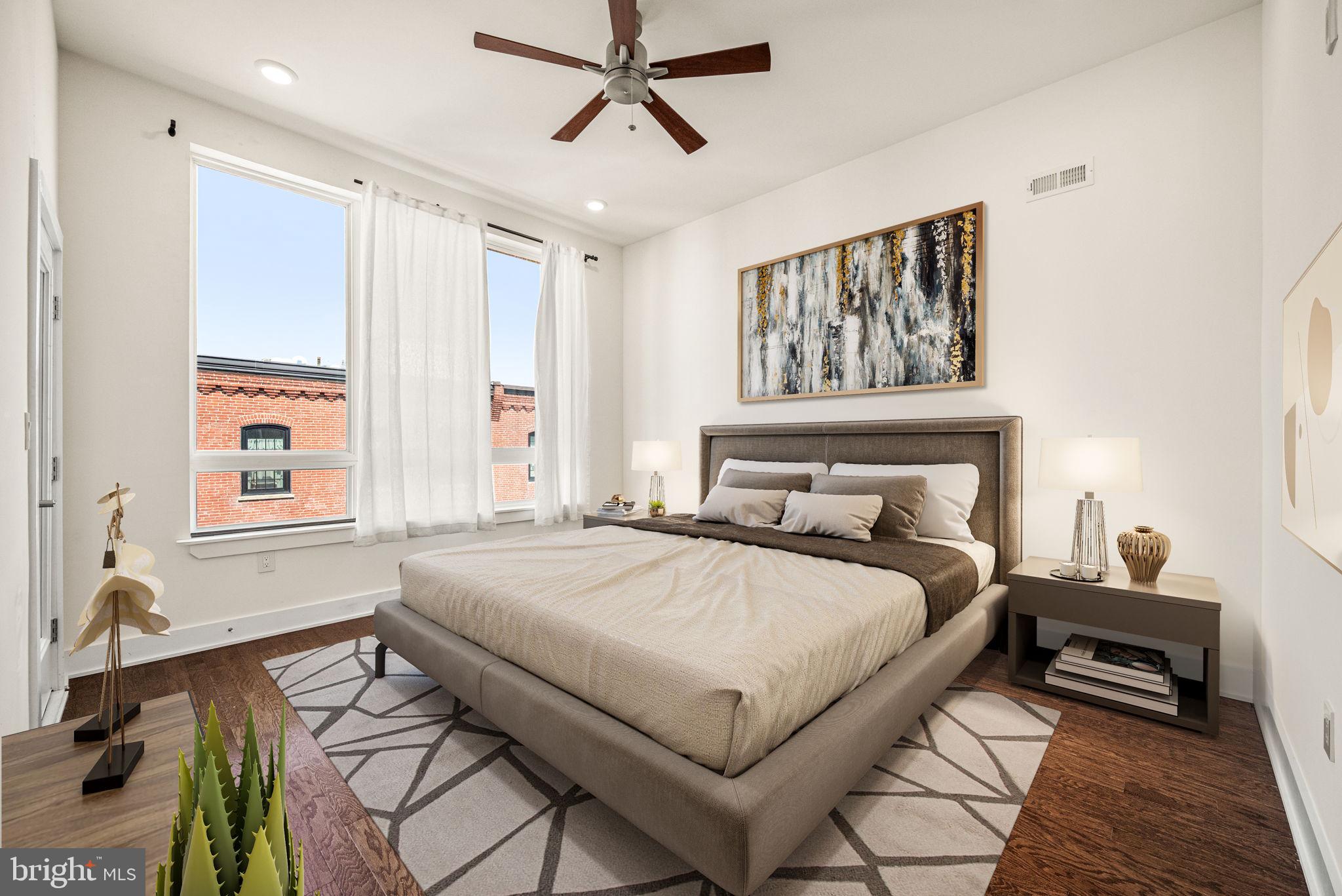 1115 North American Street, Unit D5 Philadelphia, PA 19123 - Photo 32 of 52 a bedroom with a bed and wooden floor