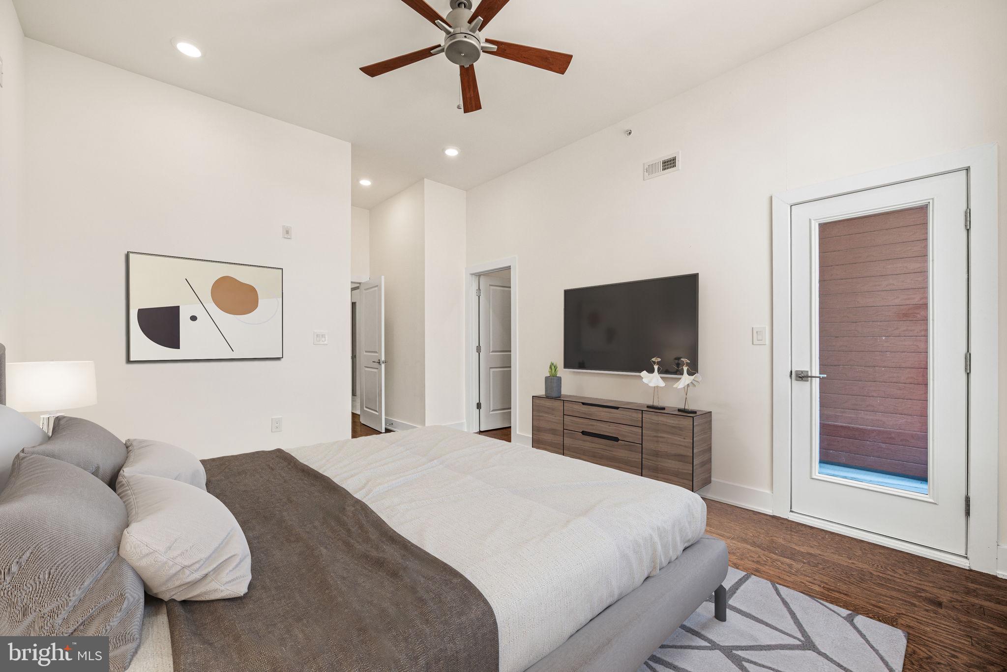 1115 North American Street, Unit D5 Philadelphia, PA 19123 - Photo 34 of 52 a bedroom with a bed and a flat screen tv