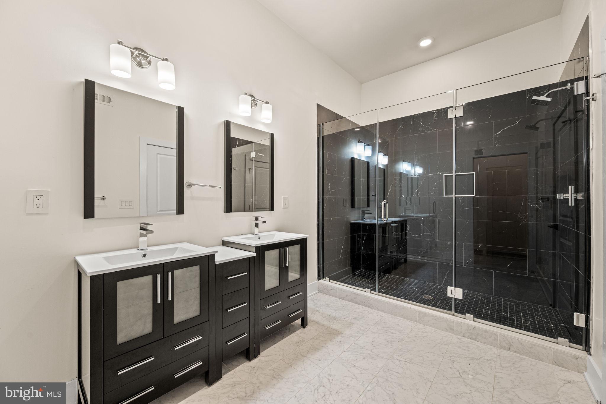 1115 North American Street, Unit D5 Philadelphia, PA 19123 - Photo 39 of 52 a bathroom with a shower sink and mirror