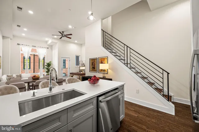 a kitchen with sink stove and cabinets