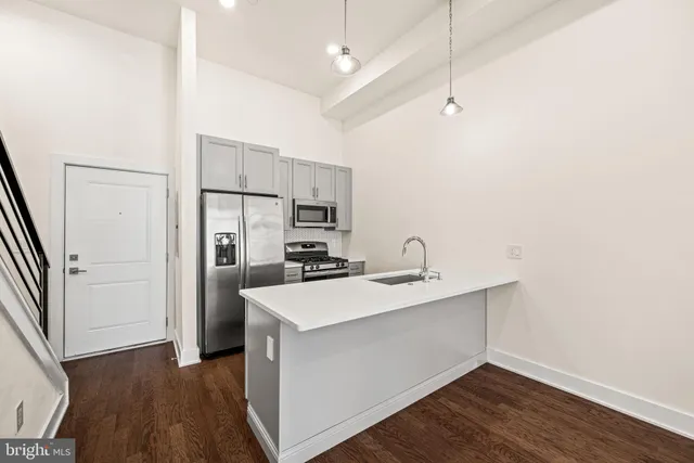 a kitchen with kitchen island a sink appliances and cabinets