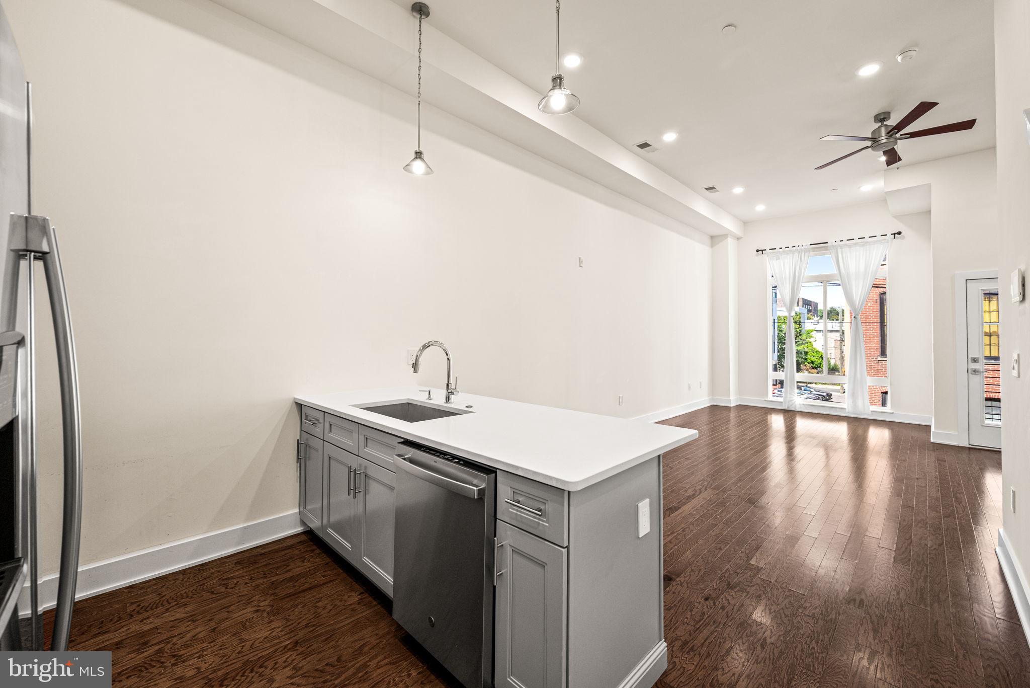 1115 North American Street, Unit D5 Philadelphia, PA 19123 - Photo 8 of 52 a view of a sink and dishwasher with wooden floor