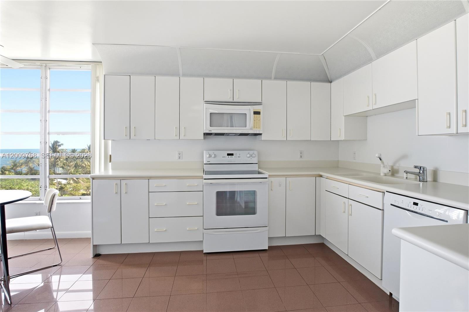 605 Ocean Drive, Unit 7L Key Biscayne, FL 33149 - Photo 11 of 38 a kitchen with cabinets appliances and a large window
