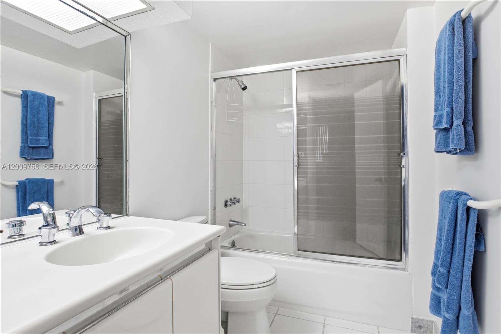 605 Ocean Drive, Unit 7L Key Biscayne, FL 33149 - Photo 13 of 38 a bathroom with a sink toilet and shower