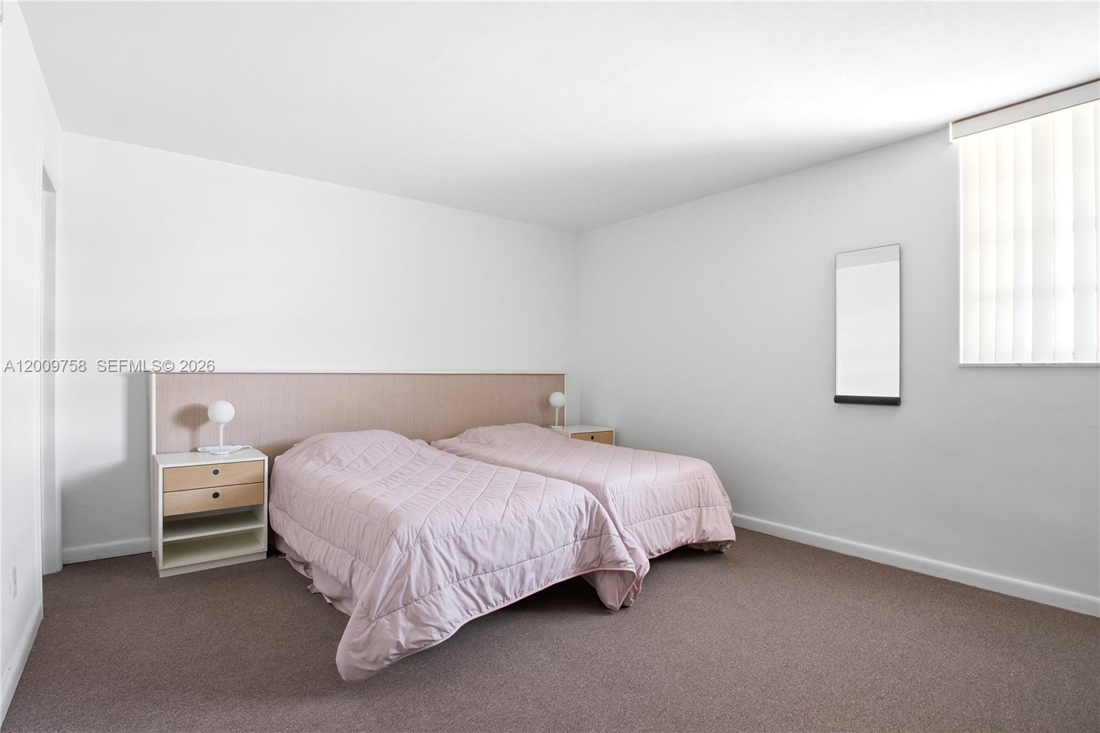 605 Ocean Drive, Unit 7L Key Biscayne, FL 33149 - Photo 14 of 38 a bed room with a bed and a chair