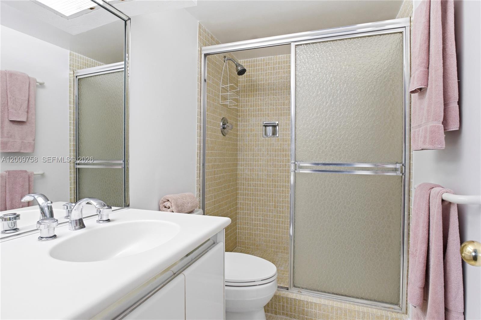605 Ocean Drive, Unit 7L Key Biscayne, FL 33149 - Photo 15 of 38 a bathroom with a sink toilet and shower