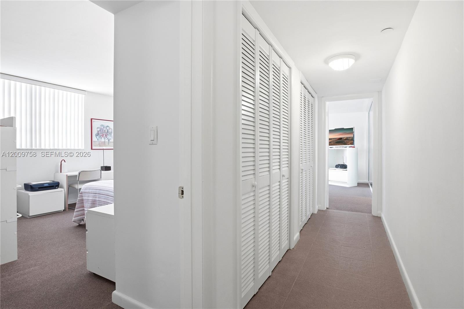 605 Ocean Drive, Unit 7L Key Biscayne, FL 33149 - Photo 16 of 38 a view of a hallway with bathroom and a sink