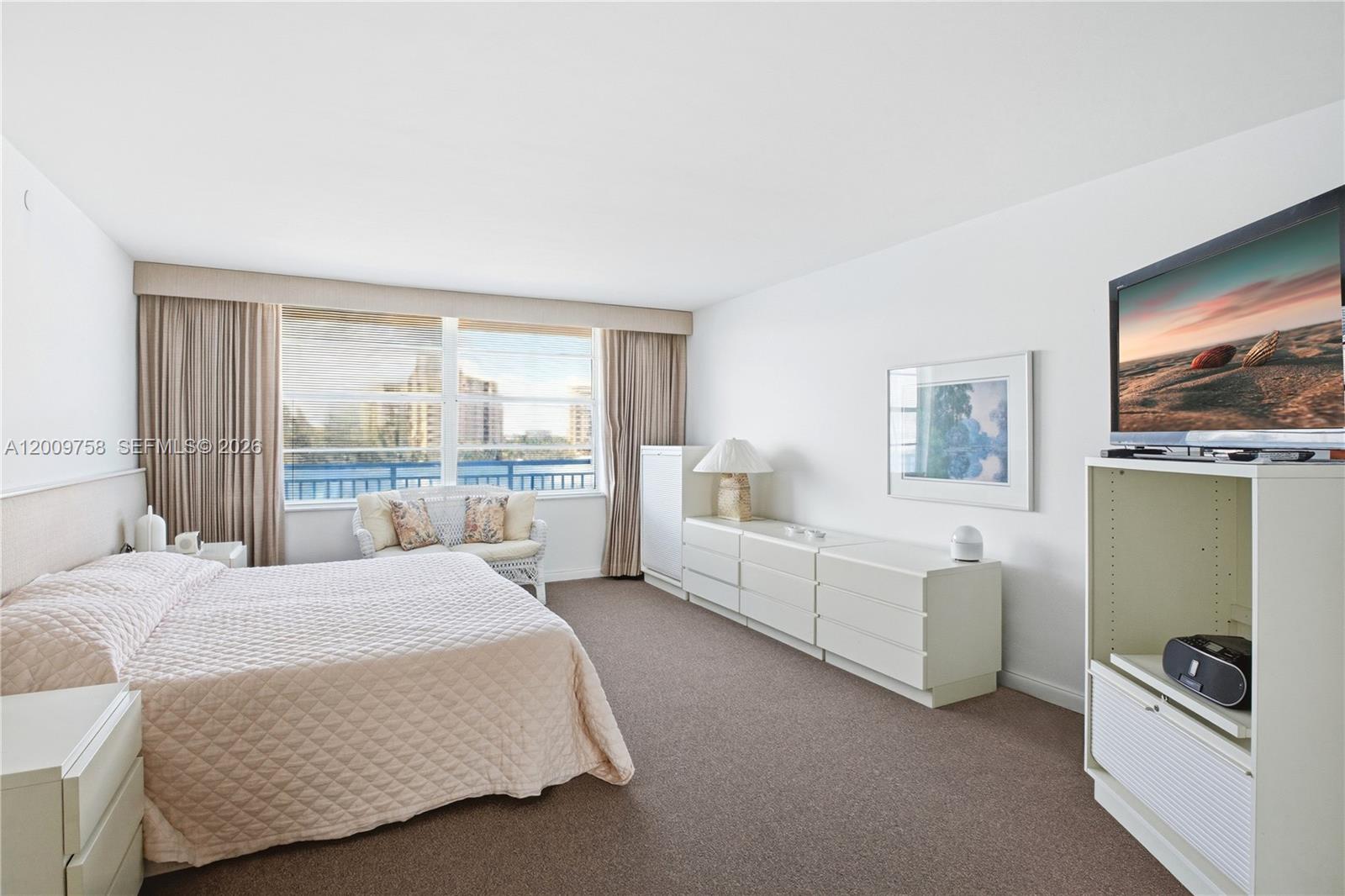 605 Ocean Drive, Unit 7L Key Biscayne, FL 33149 - Photo 17 of 38 a bedroom with a bed and a large window