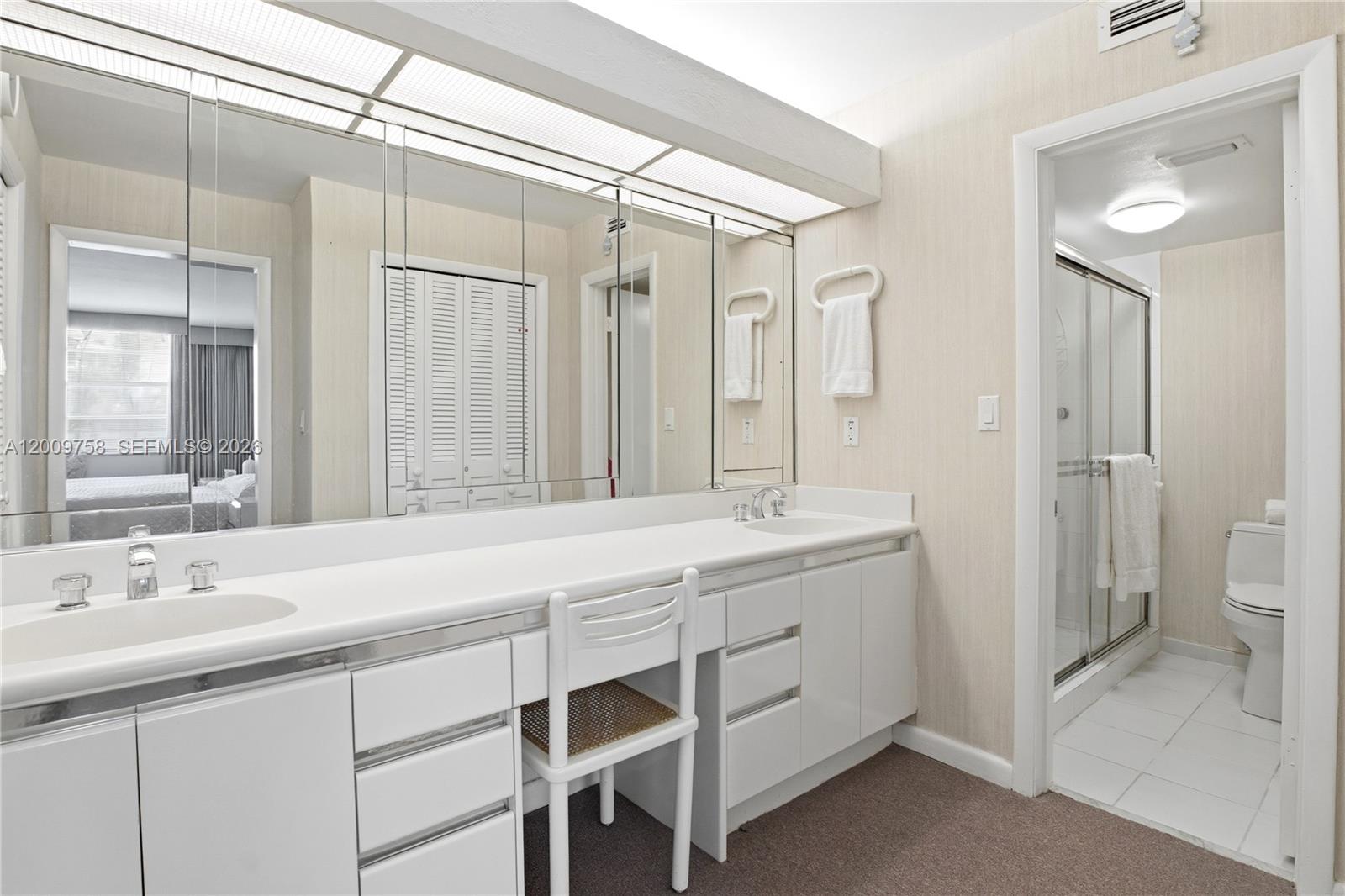 605 Ocean Drive, Unit 7L Key Biscayne, FL 33149 - Photo 18 of 38 a bathroom with a double vanity sink mirror and toilet