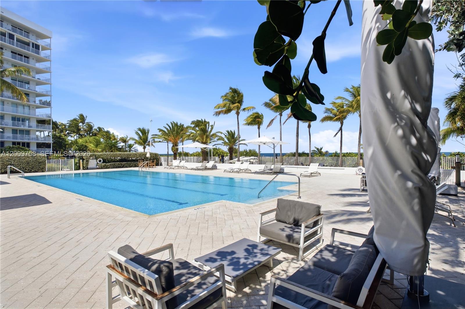 605 Ocean Drive, Unit 7L Key Biscayne, FL 33149 - Photo 25 of 38 a view of a patio with swimming pool