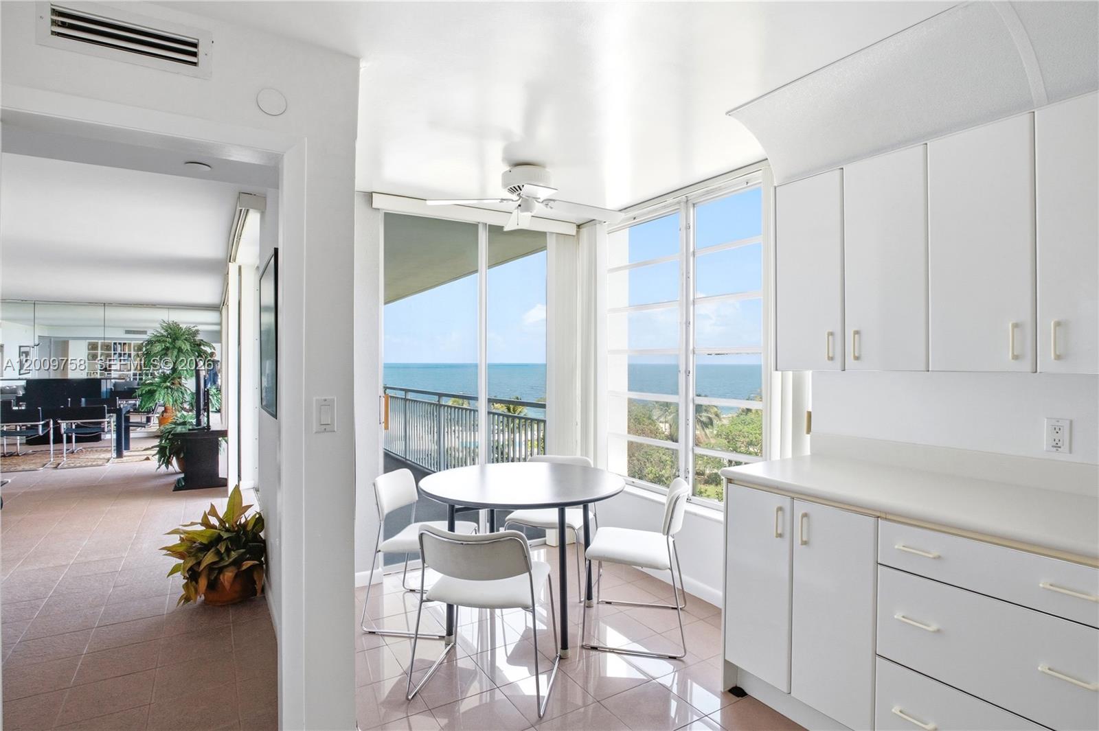605 Ocean Drive, Unit 7L Key Biscayne, FL 33149 - Photo 9 of 38 a kitchen with a table chairs and entryway