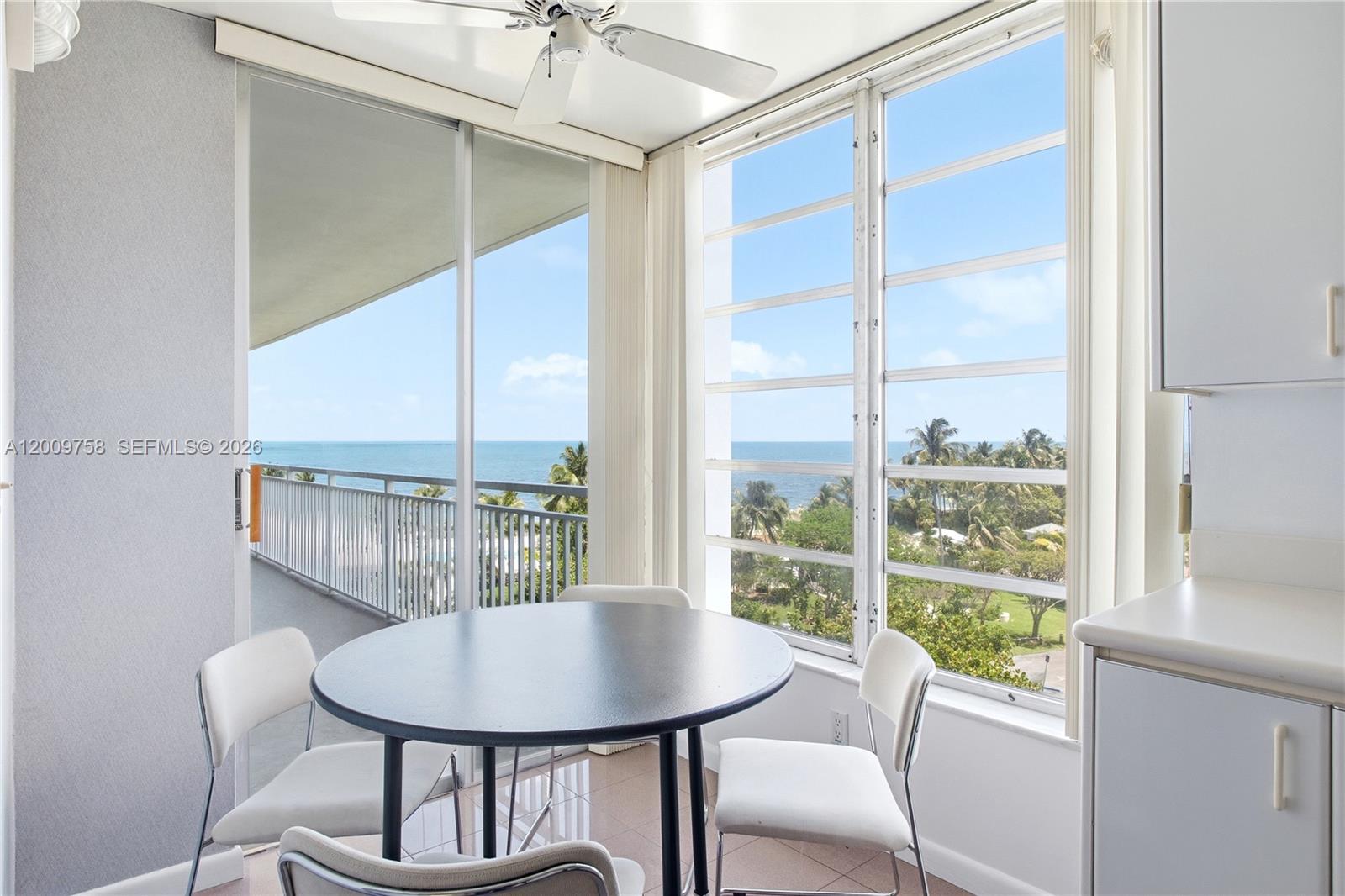 605 Ocean Drive, Unit 7L Key Biscayne, FL 33149 - Photo 10 of 38 a view of a dining room with furniture window and outside view