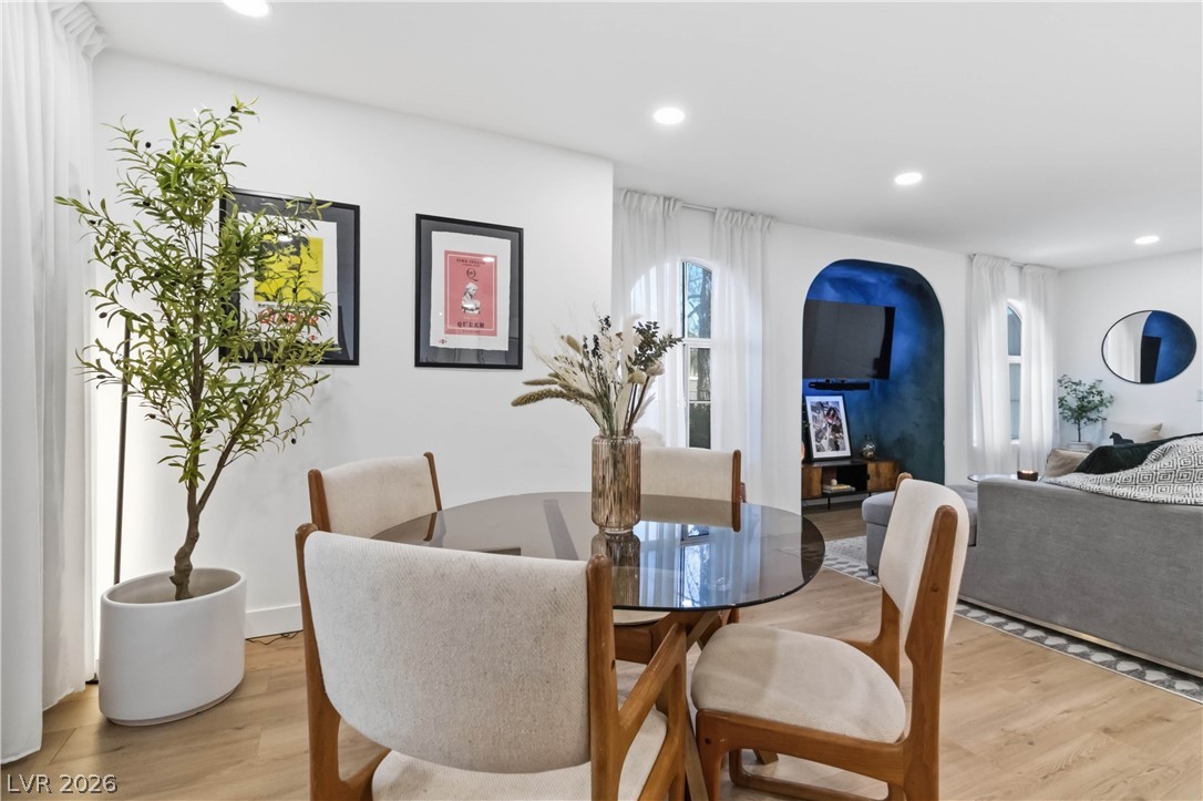 7950 West Flamingo Road, Unit 1180 Las Vegas, NV 89147 - Photo 9 of 26 Elegant dining space flows into a chic living area, perfect for entertaining guests.