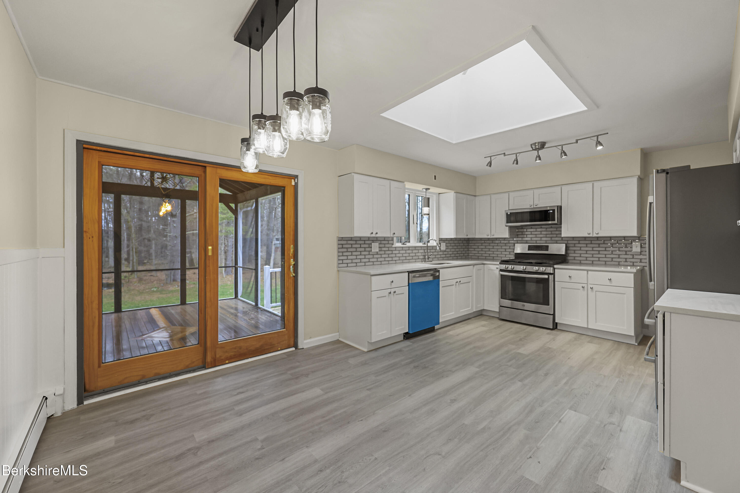 627 Lenox Road Richmond, MA 01254 - Photo 14 of 37 a kitchen with stainless steel appliances granite countertop a refrigerator a stove top oven a sink dishwasher and white cabinets with wooden floor