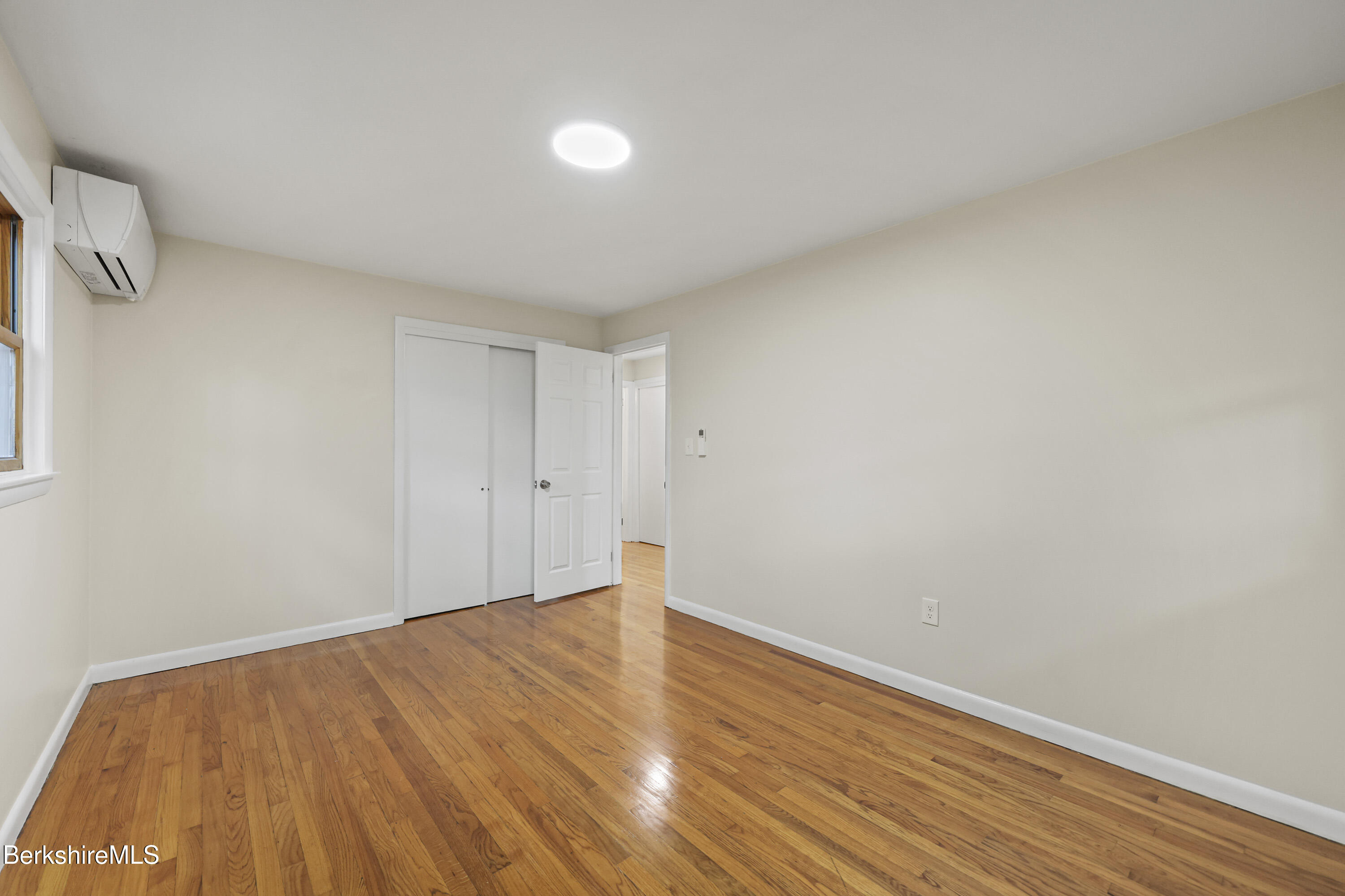 627 Lenox Road Richmond, MA 01254 - Photo 27 of 37 a view of empty room with wooden floor and fan