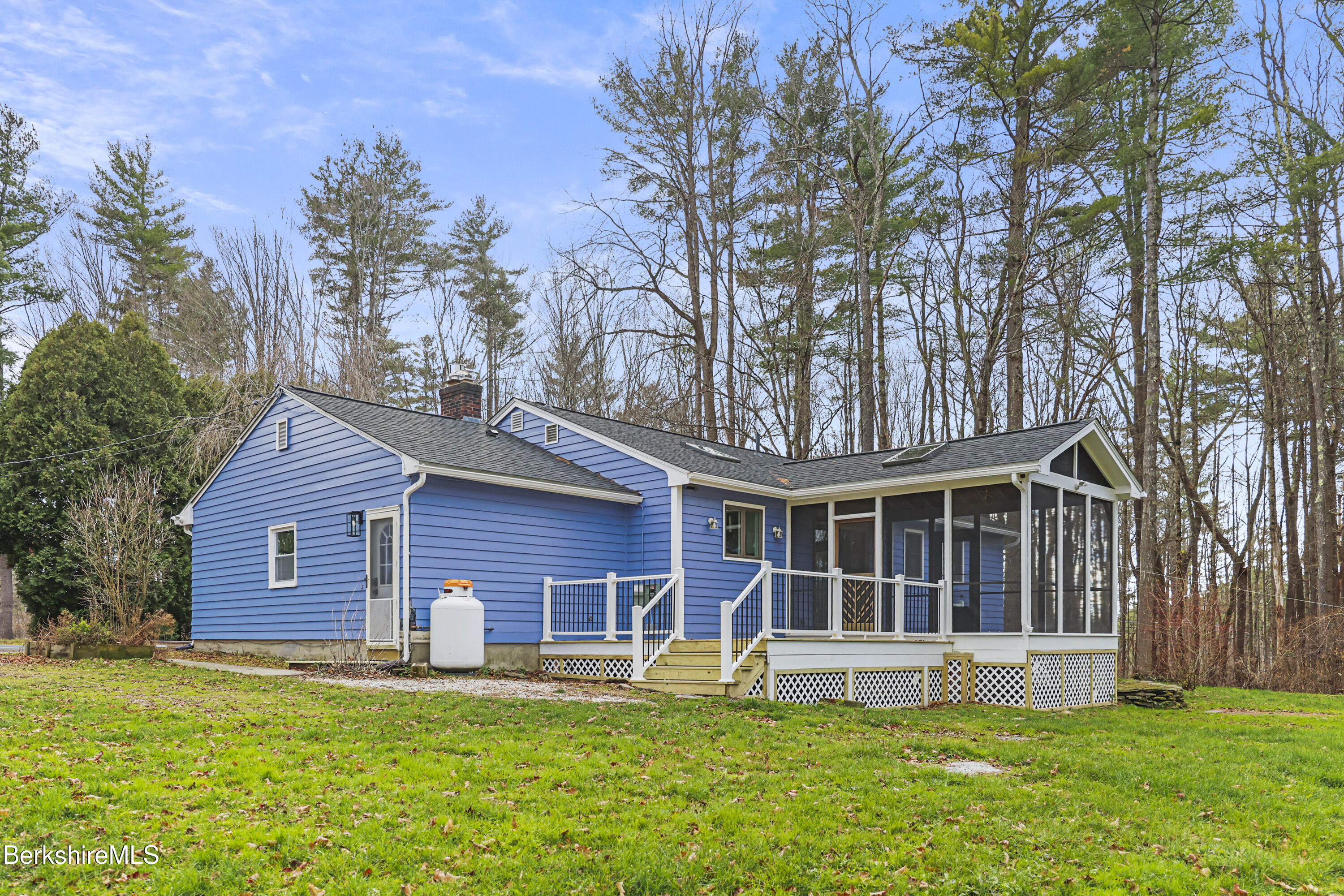 627 Lenox Road Richmond, MA 01254 - Photo 5 of 37 a front view of a house with a yard