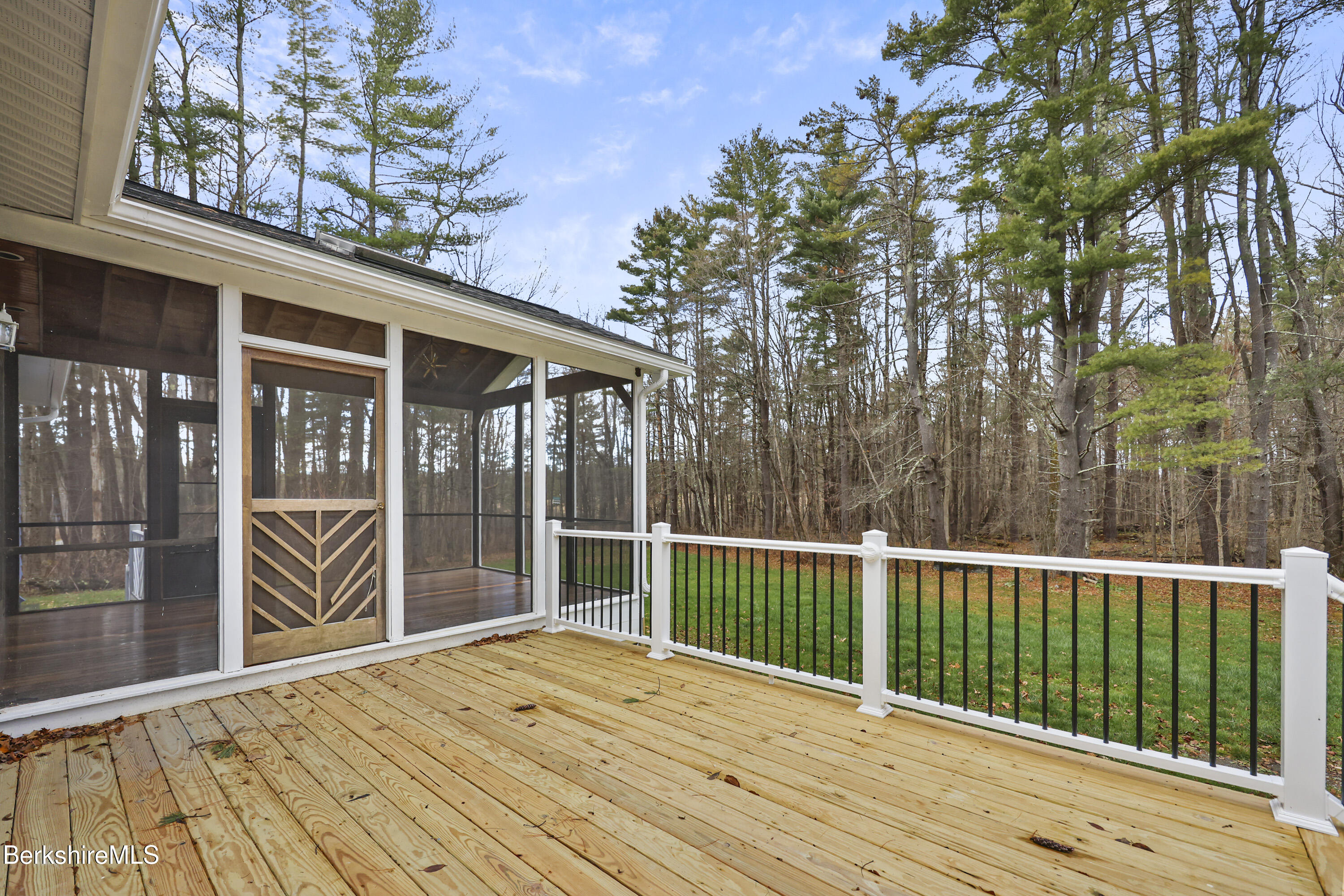 627 Lenox Road Richmond, MA 01254 - Photo 10 of 37 a view of backyard with large trees and wooden floor