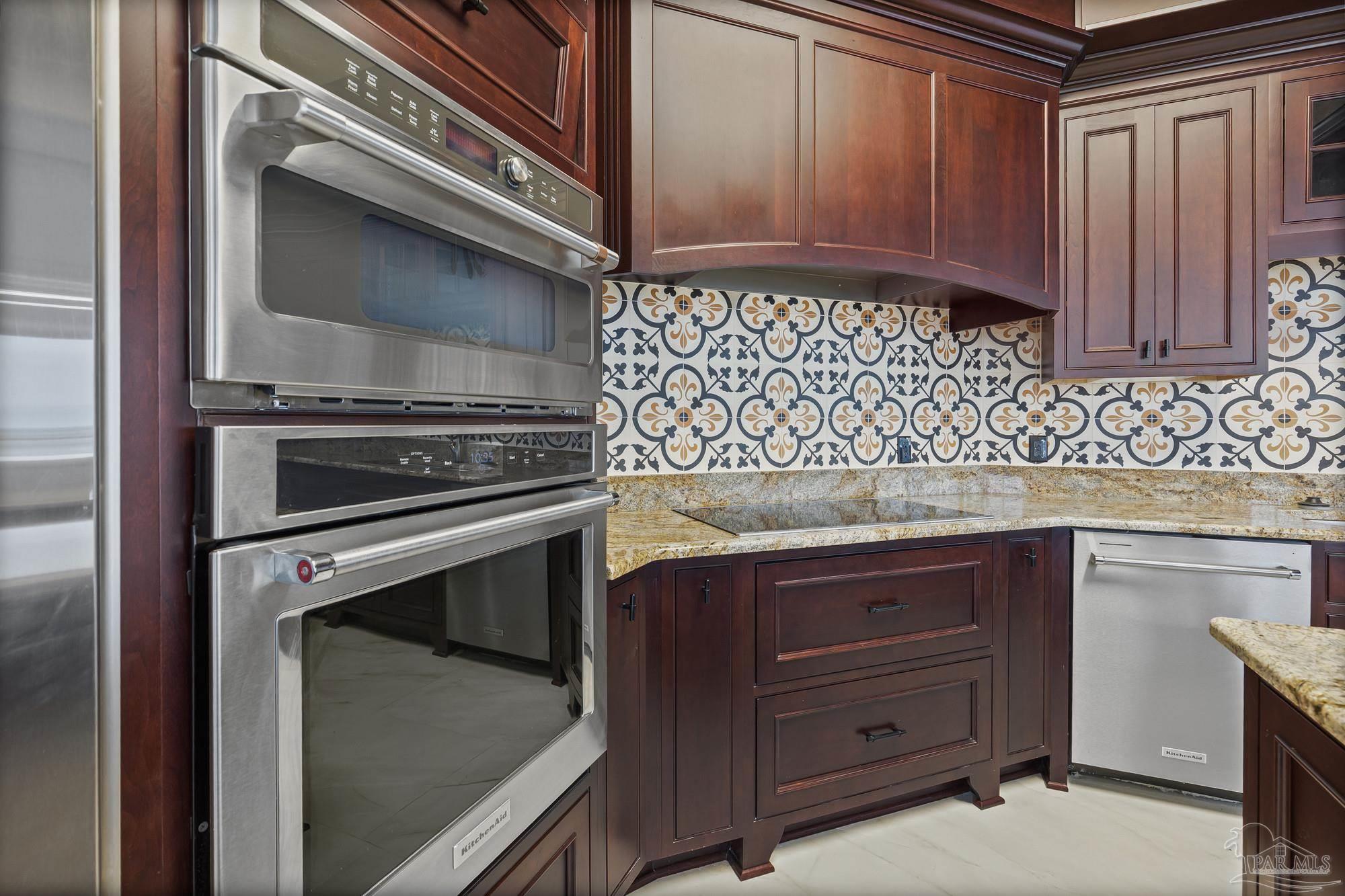 14900 River Road, Unit 904 Perdido Key, FL 32507 - Photo 15 of 62 a kitchen with granite countertop cabinets and window