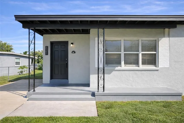 a view of a house with backyard porch and sitting area