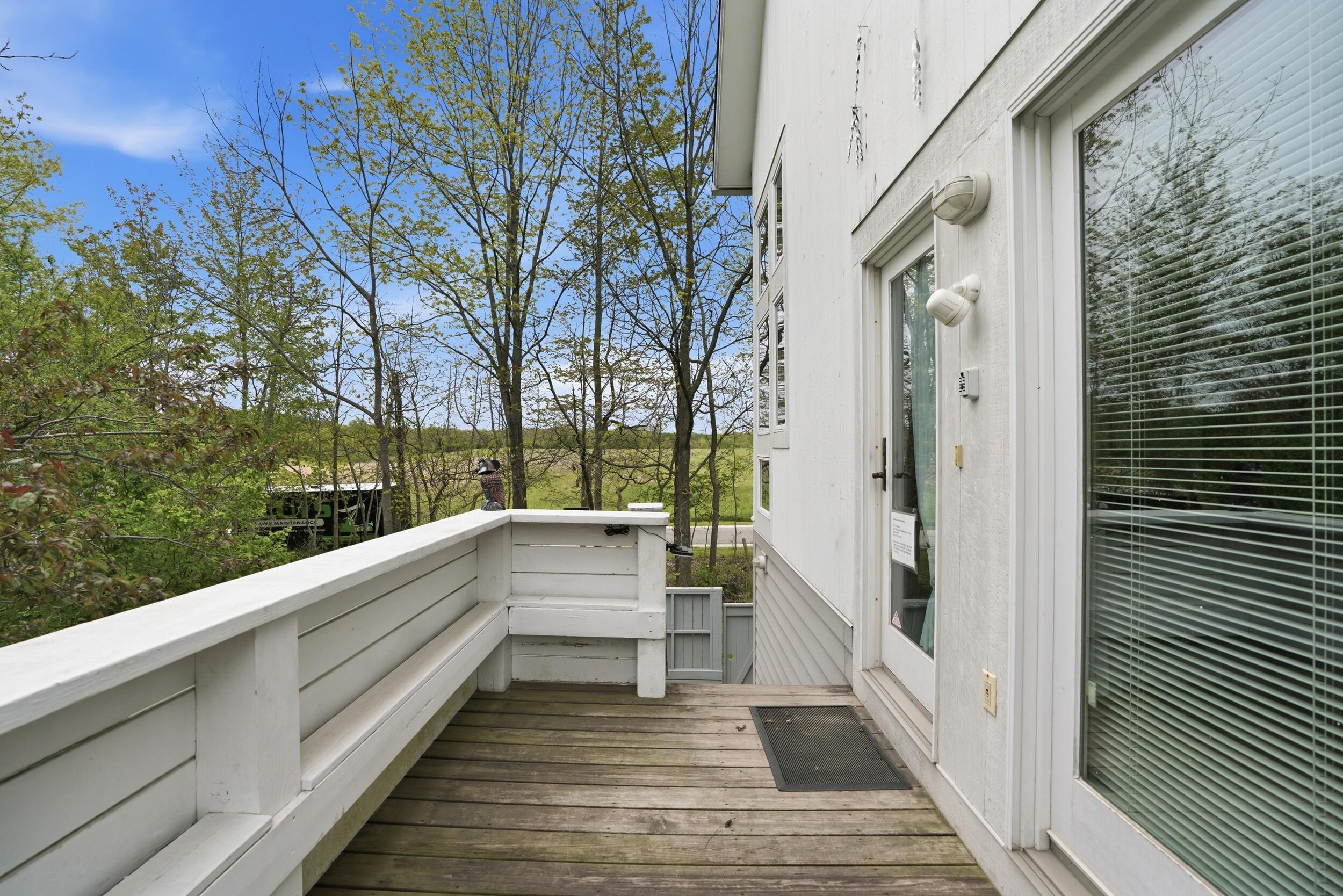 10 Tryon Farm Lane, Unit F10 Michigan City, IN 46360 - Photo 5 of 32 a view of a balcony with wooden floor and fence