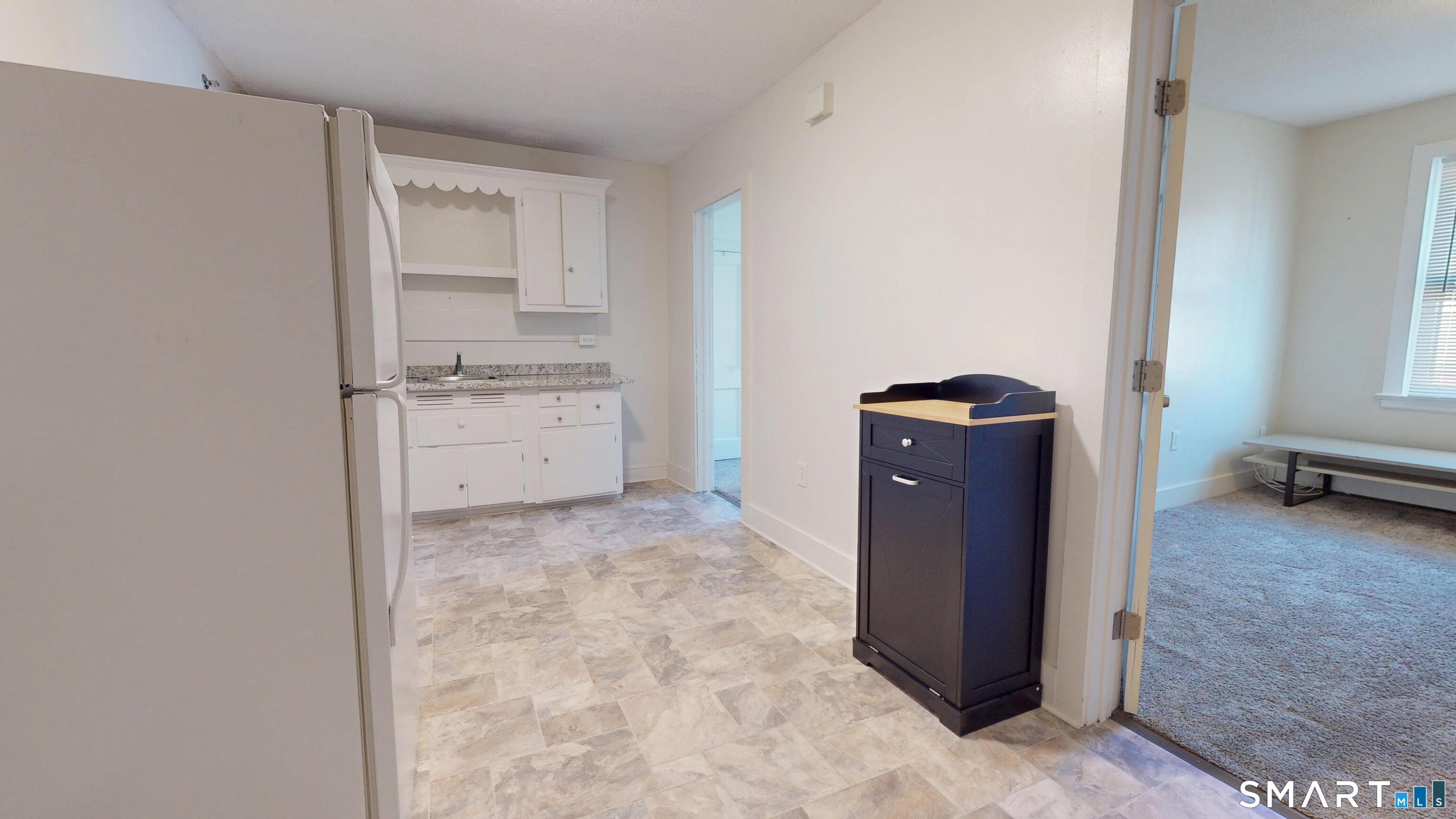 a view of a storage and utility room with a stove