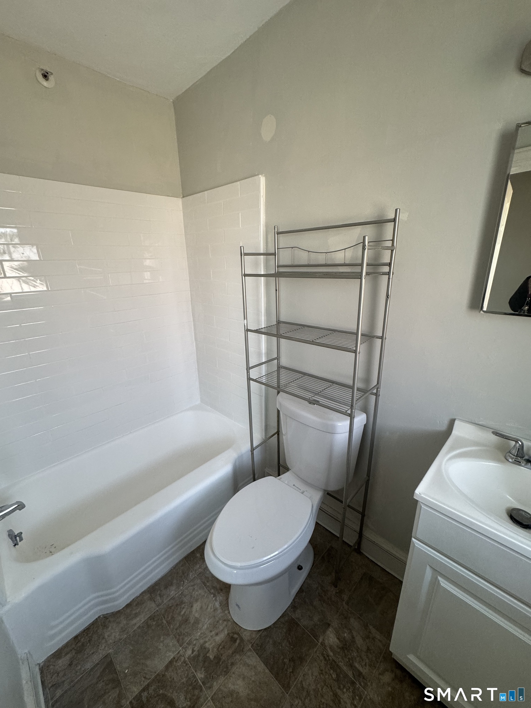 666 Main Street, Unit C2 Middletown, CT 06457 - Photo 6 of 6 a white toilet and tub next to a bathroom sink