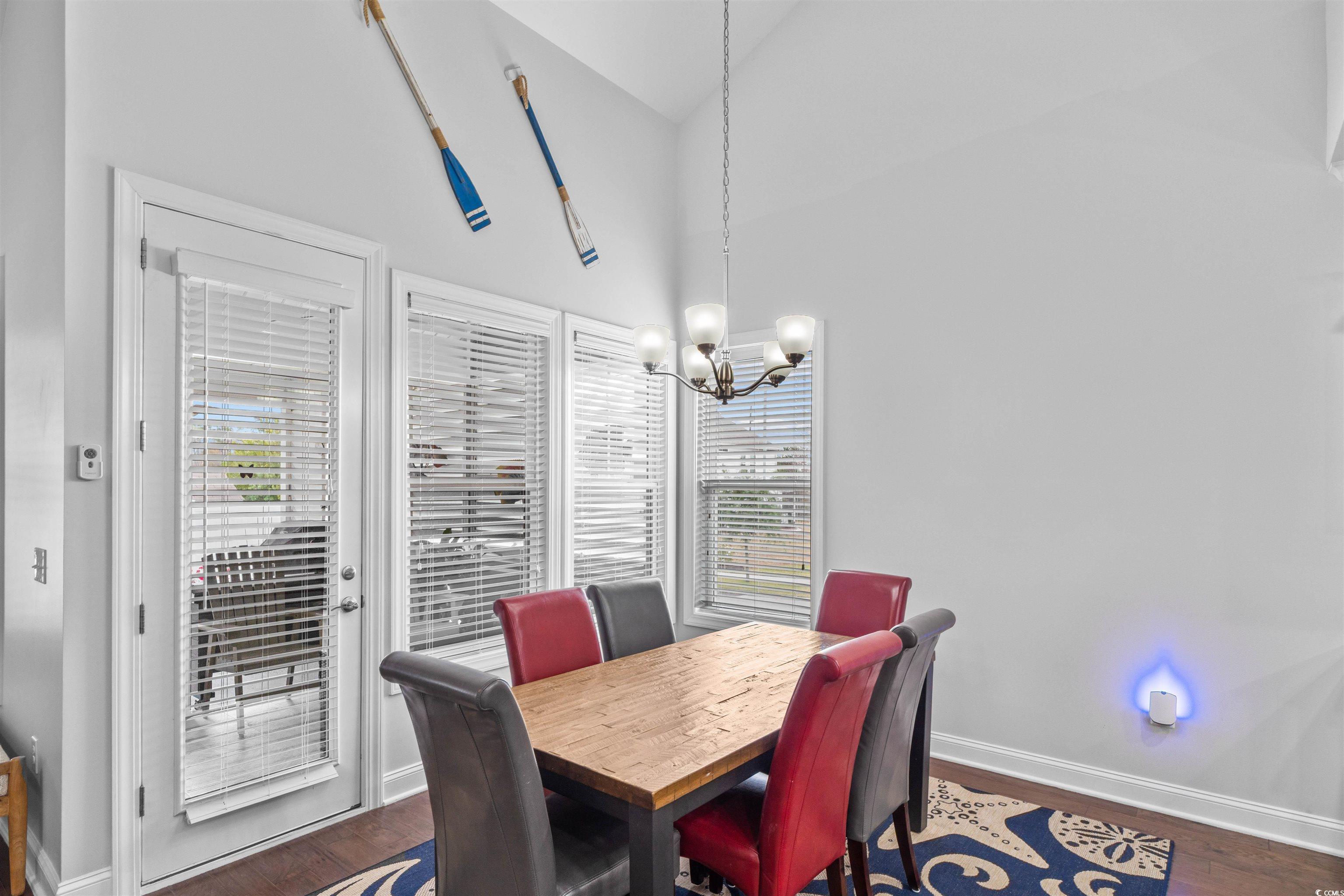 1141 Bronwyn Circle North Myrtle Beach, SC 29582 - Photo 13 of 40 Dining room featuring dark wood-style flooring, high vaulted ceiling, and a chandelier