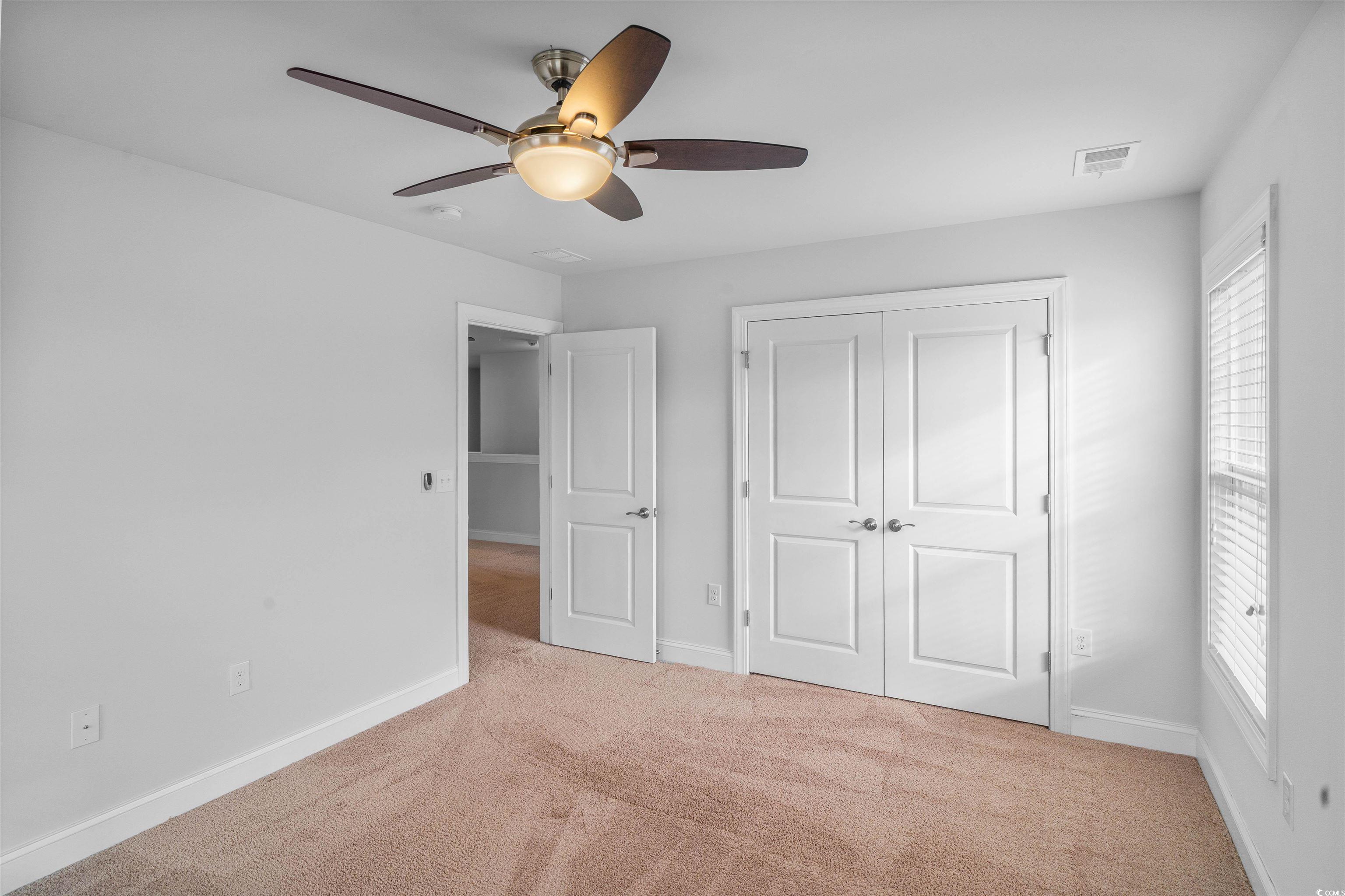 1141 Bronwyn Circle North Myrtle Beach, SC 29582 - Photo 30 of 40 Unfurnished bedroom featuring carpet flooring, ceiling fan, and a closet