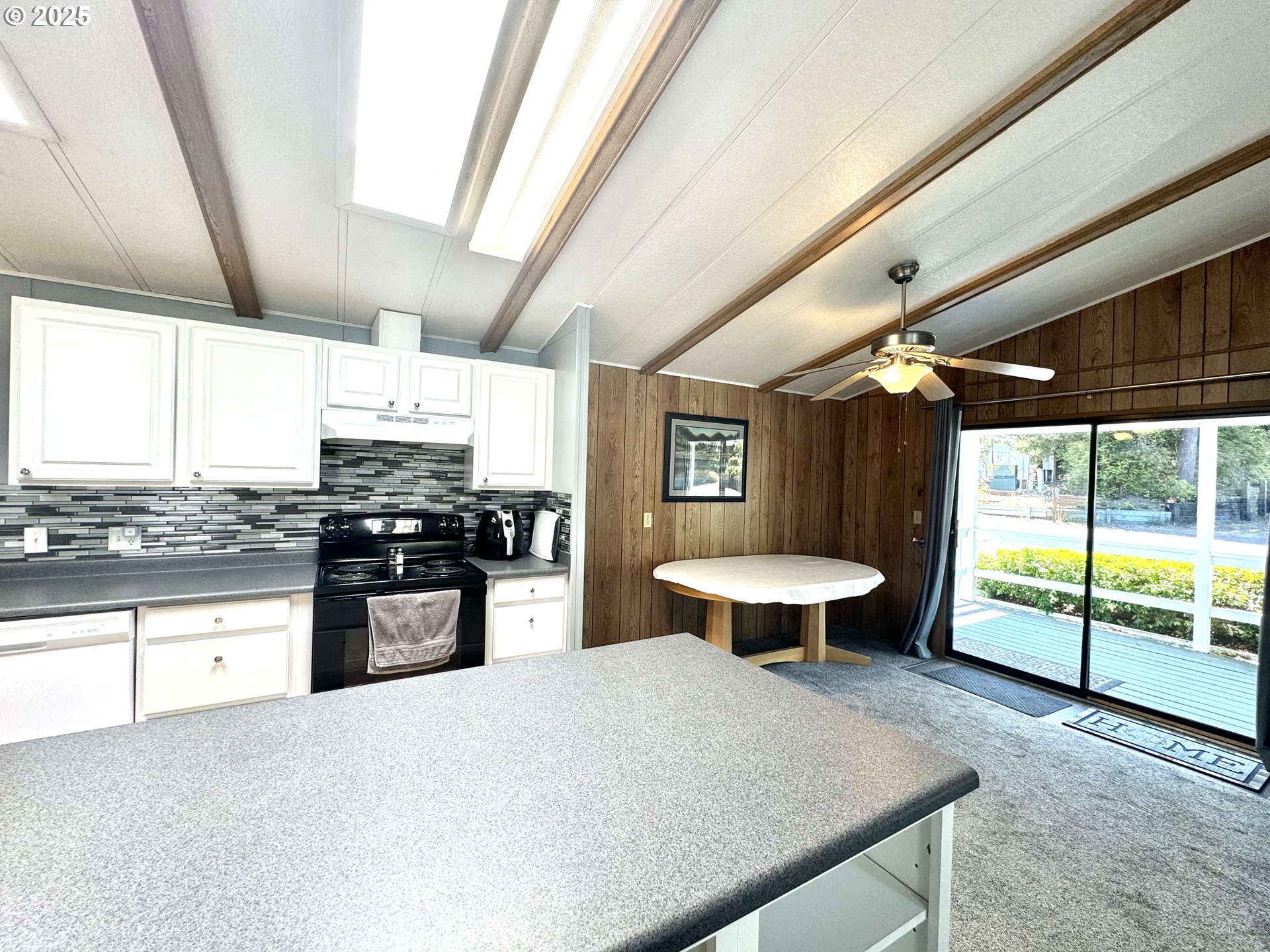 1601 Rhododendron Drive, Unit 676 Florence, OR 97439 - Photo 13 of 36 a kitchen with stainless steel appliances granite countertop a sink a stove and a wooden floors