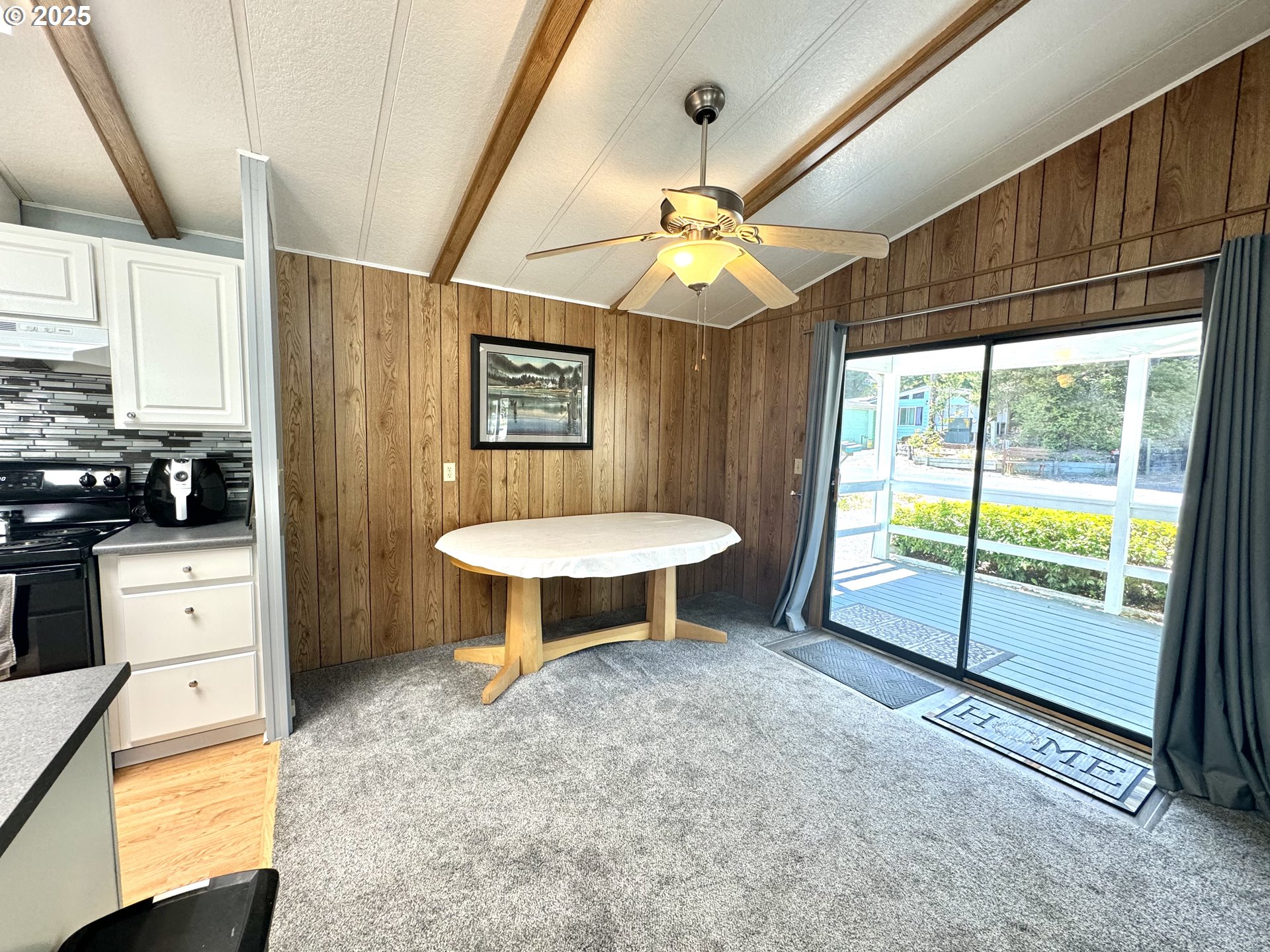 1601 Rhododendron Drive, Unit 676 Florence, OR 97439 - Photo 14 of 36 a view of a livingroom with furniture hardwood floor and a ceiling fan