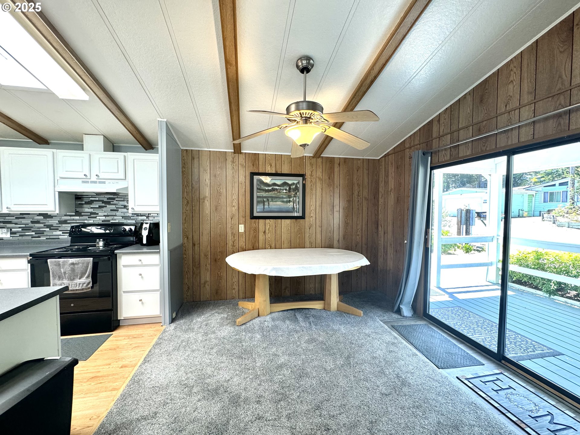 1601 Rhododendron Drive, Unit 676 Florence, OR 97439 - Photo 15 of 36 a kitchen with stainless steel appliances granite countertop a sink a stove and a wooden floors