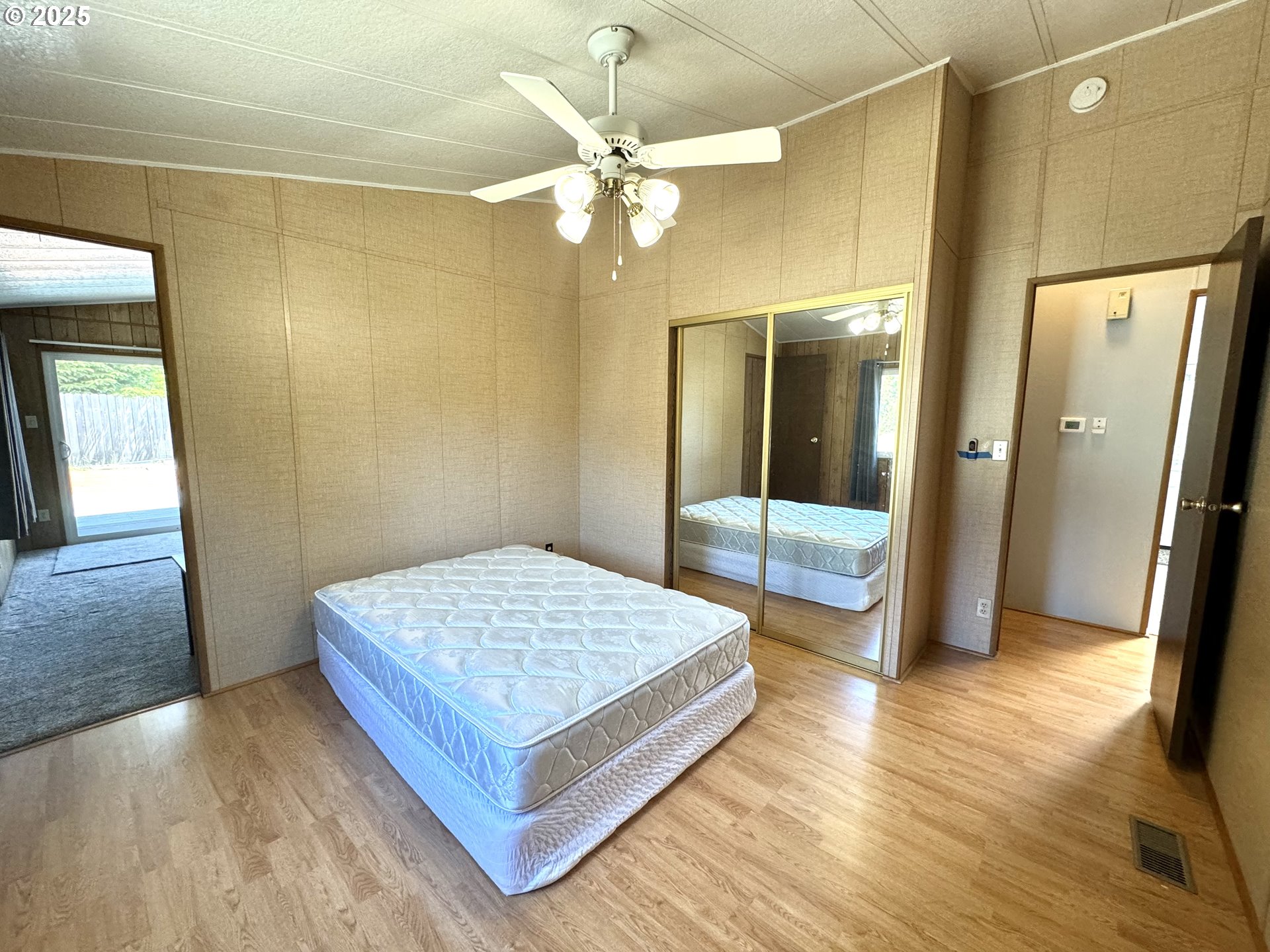 1601 Rhododendron Drive, Unit 676 Florence, OR 97439 - Photo 22 of 36 a bedroom with a bed and wooden floor