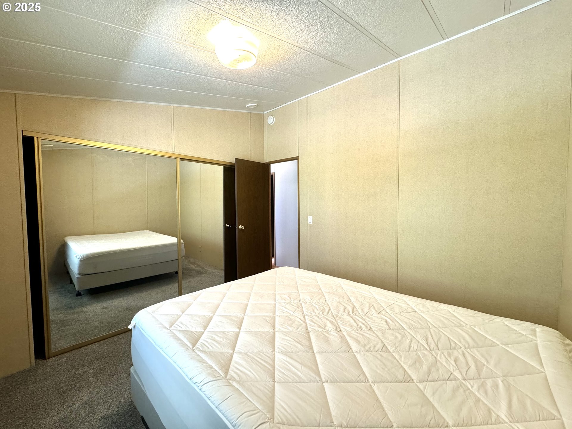 1601 Rhododendron Drive, Unit 676 Florence, OR 97439 - Photo 25 of 36 a bedroom with a bed and a couch