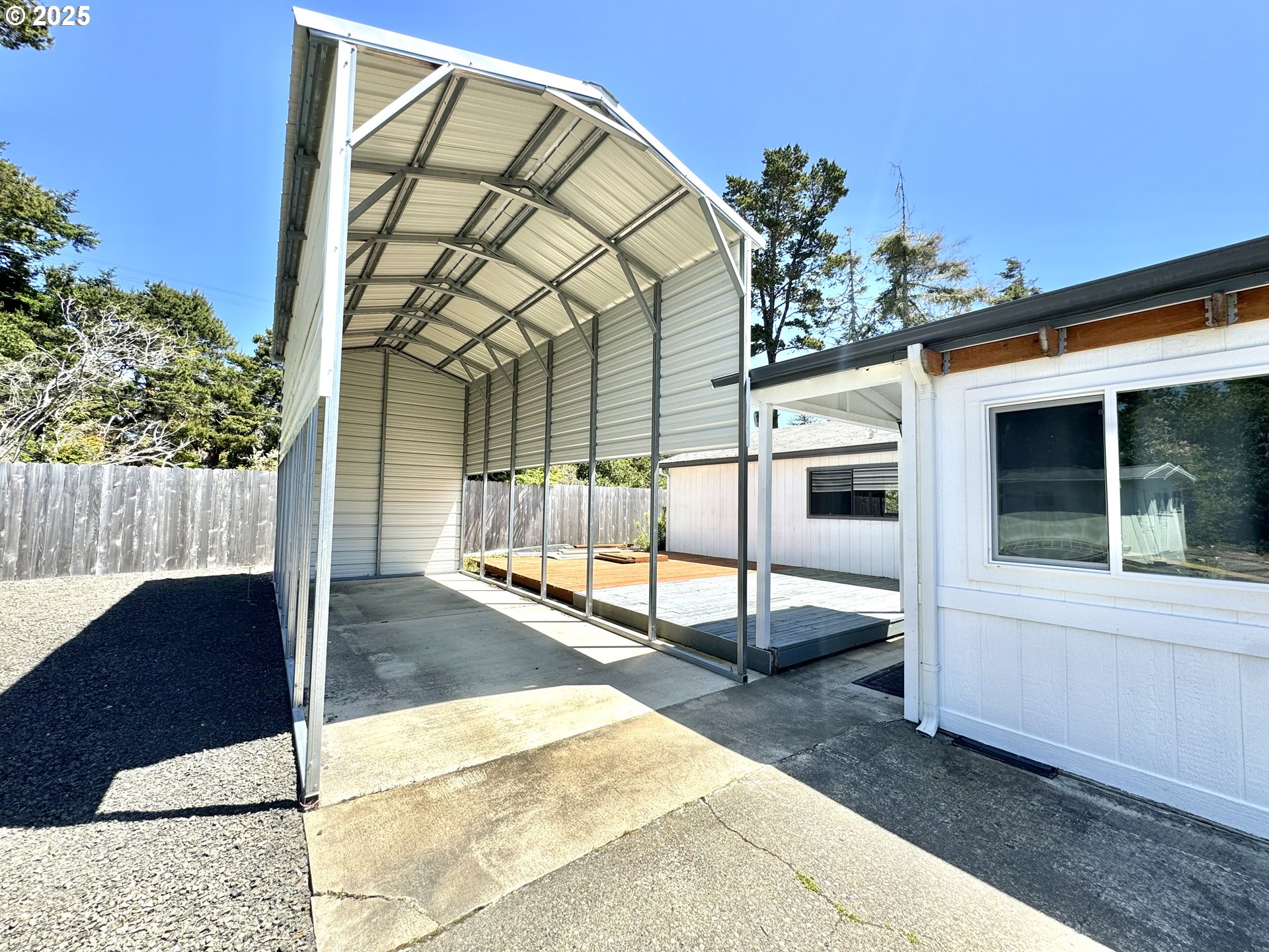1601 Rhododendron Drive, Unit 676 Florence, OR 97439 - Photo 30 of 36 a view of a porch with a table and chairs