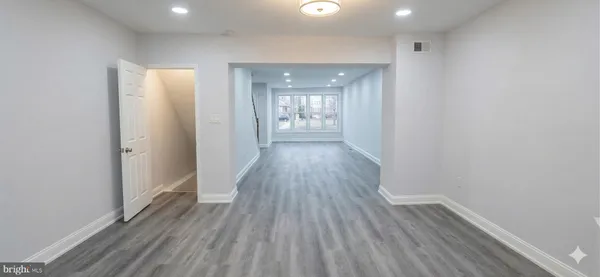 a view of hallway with wooden floor
