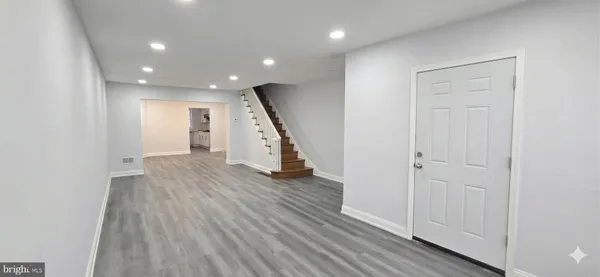 a view of a hallway with wooden floor
