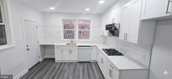 a kitchen with a sink stove and cabinets