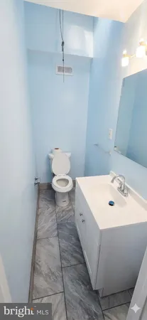 a bathroom with a sink toilet and vanity