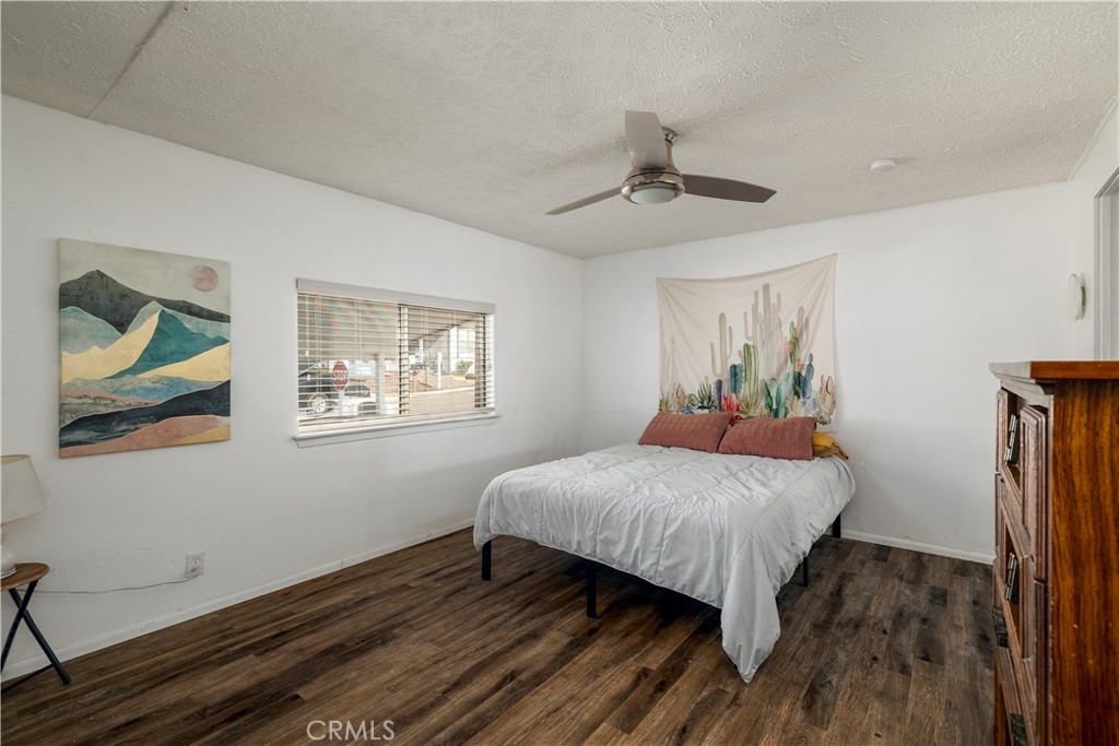 15181 Van Buren, Unit 90 Riverside, CA 92504 - Photo 12 of 27 a bedroom with a bed and wooden floor